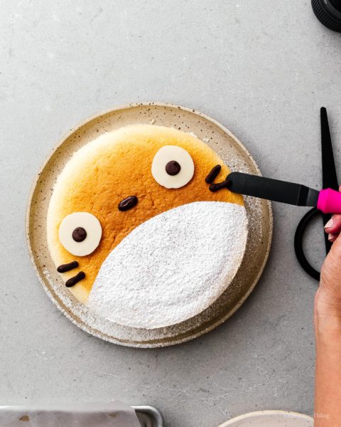 A super cute fluffy, jiggly Totoro cheesecake: pillowy soft, cotton-y, light-as-air cheesecake with just a hint of sweetness. #cheesecake #japanesecheesecake #fluffycheesecake #totorocake #totorocheesecake #totorofood #kawaiifood