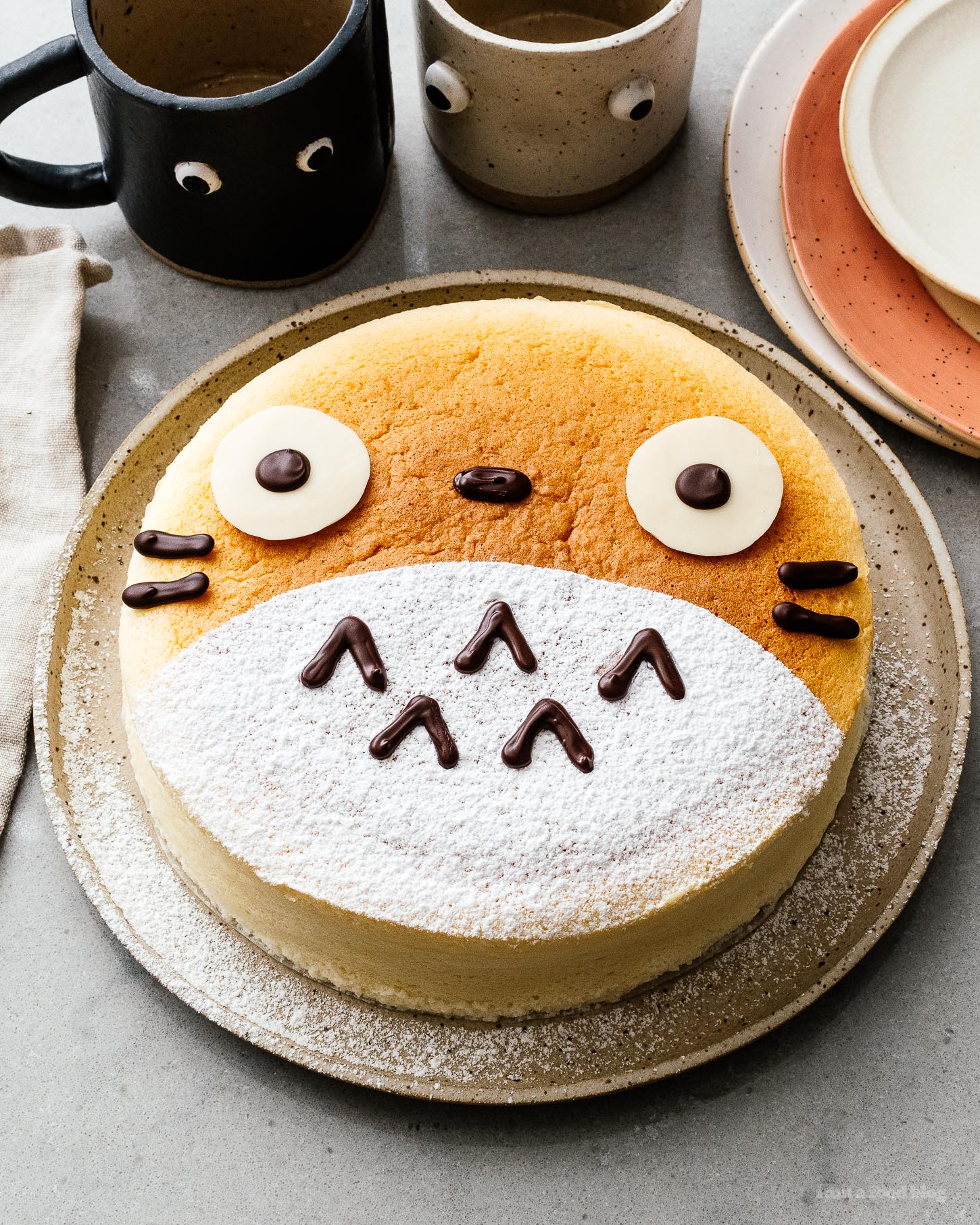 A super cute fluffy, jiggly Totoro cheesecake: pillowy soft, cotton-y, light-as-air cheesecake with just a hint of sweetness. #cheesecake #japanesecheesecake #fluffycheesecake #totorocake #totorocheesecake #totorofood #kawaiifood