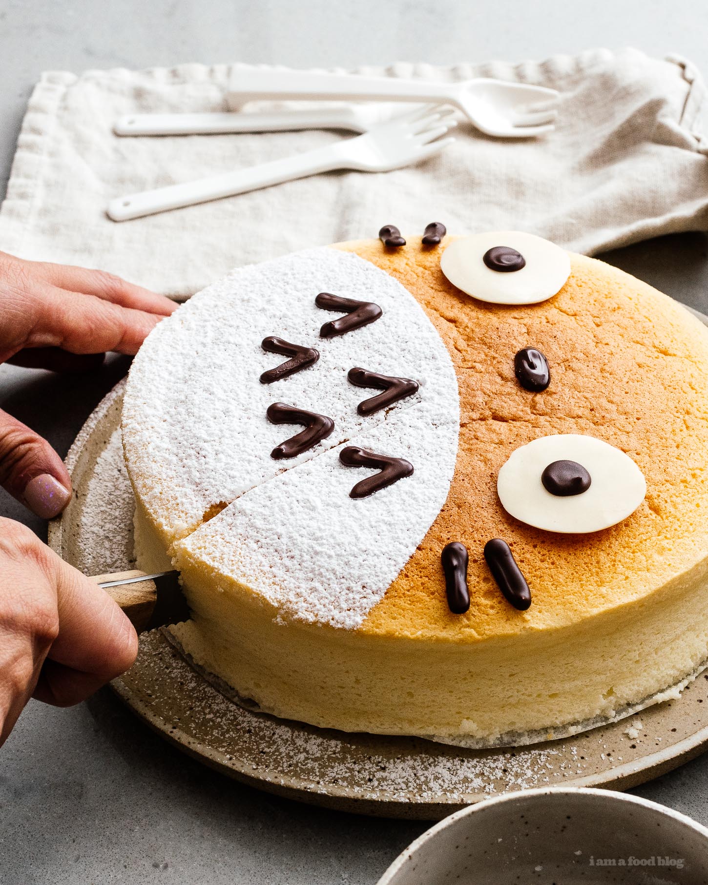 A super cute fluffy, jiggly Totoro cheesecake: pillowy soft, cotton-y, light-as-air cheesecake with just a hint of sweetness. #cheesecake #japanesecheesecake #fluffycheesecake #totorocake #totorocheesecake #totorofood #kawaiifood