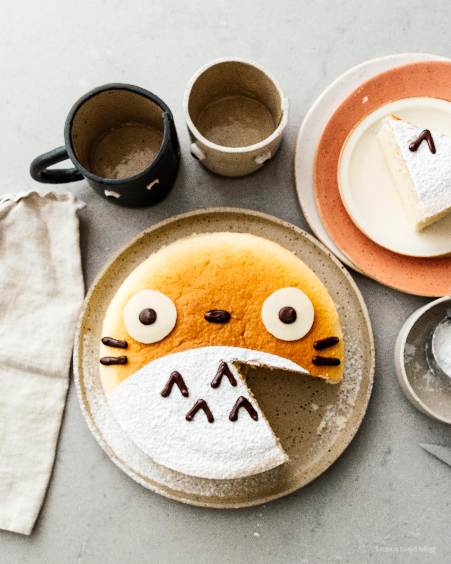 A super cute fluffy, jiggly Totoro cheesecake: pillowy soft, cotton-y, light-as-air cheesecake with just a hint of sweetness. #cheesecake #japanesecheesecake #fluffycheesecake #totorocake #totorocheesecake #totorofood #kawaiifood